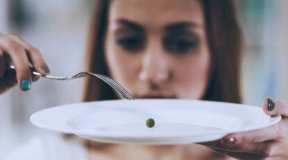 Person eats one pea on a plate.