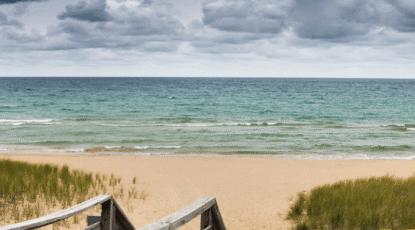 Great Lakes waterfront with sand and grasses.