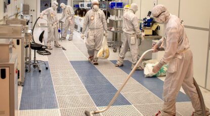 Workers wear head-to-toe protective gear in U-M's Lurie Nanofabrication Facility on North Campus.