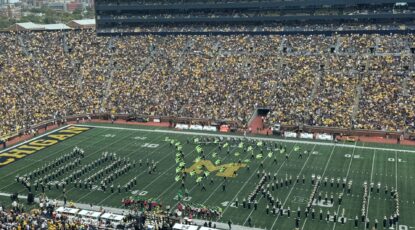 The University of Michigan Marching Band creates a formation that spells "Wicked" as they perform songs from the popular Broadway musical.