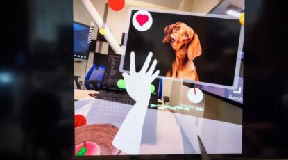 HandProxy, developed at the University of Michigan, touches objects inside a demo app. The hand is guided by voice commands. (Photo: Marcin Szczepanski, Michigan Engineering.)