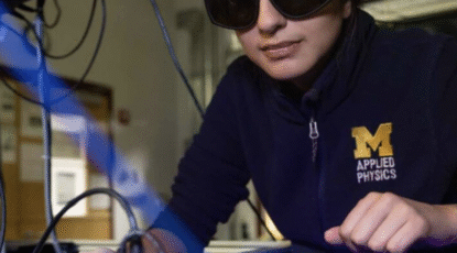 University of Michigan cientist wearing safety goggles does work in applied physics.