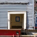 Sign inside shabby house reads: This house is being saved. Do not damage."