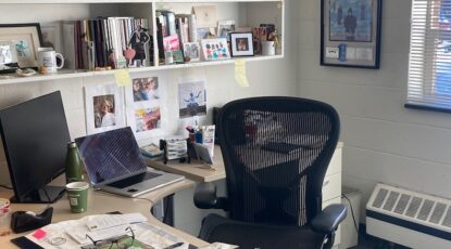 Desk setting amid cincerblock walls.