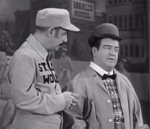 Black and white image of Abbott and Costello performing their iconic routing Who's On First.
