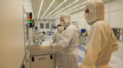 Researchers dressed in full-body "rabbit suits" while working in a clean room at the University of Michigan's Lurie Nanofabrication Facility.