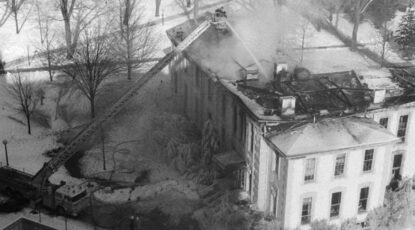 Black and white photo of crews fighting a fire in the Economics Building at University of Michigan in Ann Arbor on Christmas Even 1981.