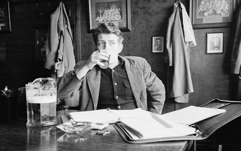 Young caucasian man sips a glass of beer while examining schoolwork in what appears to be a bar in Ann Arbor, Michigan, 1949. (Image credit: Stanley Kubrick, Look magazine photograph collection, Library of Congress.)
