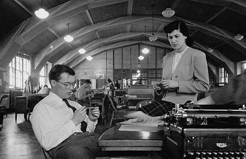 Two University of Michigan student reporters confer in the newsroom of the Michigan Daily in 1949. Caucasian male and female. (Image credit: Stanley Kubrick, Look magazine photograph collection, Library of Congress.)