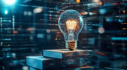 A lightbulb is energized atop a bunch of electronics amid blinking lights.