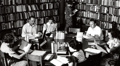 A black and white image of a study group in the book-lined Hopwood Room in 1939. Cowden, director of the Hopwood Awards from 1933 to 1952, kept a desk there. (Bentley Historical Library)