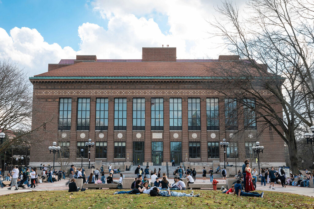 Students flock to the lawn in front of the Hatcher Graduate Library, even though the trees have yet to bloom. University of Michigan, Ann Arbor.