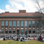 Students flock to the lawn in front of the Hatcher Graduate Library, even though the trees have yet to bloom. University of Michigan, Ann Arbor.