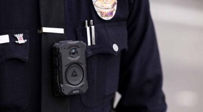 Closeup image of a police uniform with emphasis on body camera.
