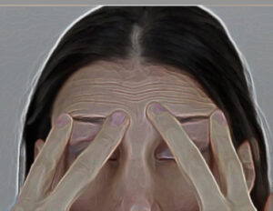 Caucasian woman pushes up skin between her eyebrows using her fingertips.