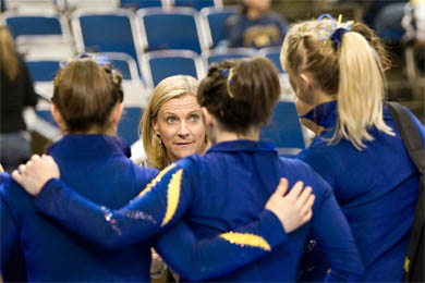 Head Coach Bev Plocki talks to the team at a meet against Iowa in February. In her 19 years at Michigan, Plocki has led the Wolverines to 15 Big Ten titles. (Photo: Scott Soderberg, U-M Photo Services.)