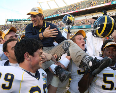 University of Michigan football coach Lloyd Carr is carried off the field by his players after winning the 2008 Capital One Bowl over Florida