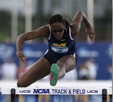 Tiffany Ofili leaps over a hurdle at the NCAA track and field championships.