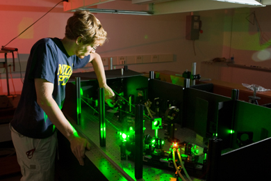 William Fisher, a doctoral student in applied physics, performing research on laser-induced magnetism.