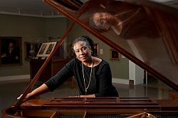 Geri Allen standing beside a piano