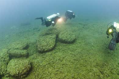 Divers examining boulders at the bottom of Lake Huron that served as caribou drive lanes for prehistoric hunters. Photo courtesy of Tane Casserly