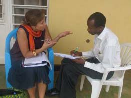 Patricia Pasick, founder of Stories for Hope, talks about the project with Kanamugire Theophile, director of a local NGO in Nyamata, Rwanda. (Photo courtesy of Patricia Pasick.)