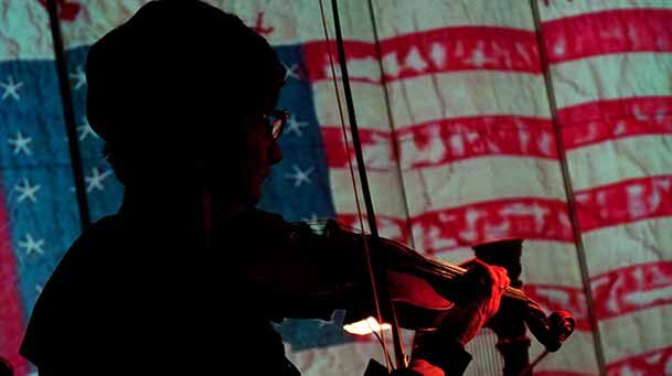 Violinist with vintage banner.