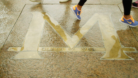 Students cross the Block M on the Diag