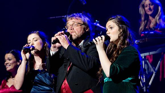 Davis singing in concert with his daughters