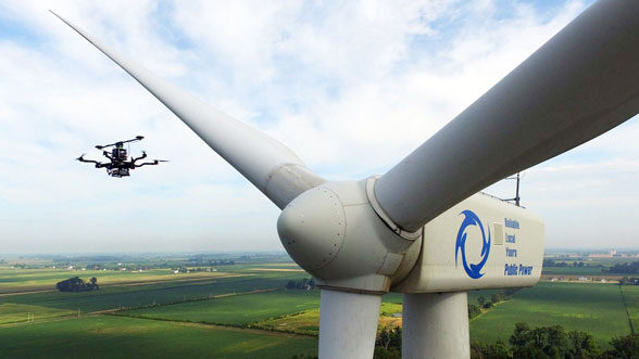 Drone inspects a wind turbine.