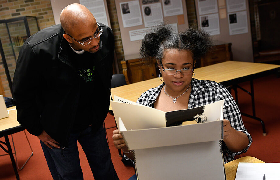 Stephen Ward, associate professor of Afroamerican and African studies, and a student examine archived materials from the Department of Afroamerican and African Studies. The materials have been newly digitized and made available online for U-M students, faculty and staff. (Image: Lon Horwedel)