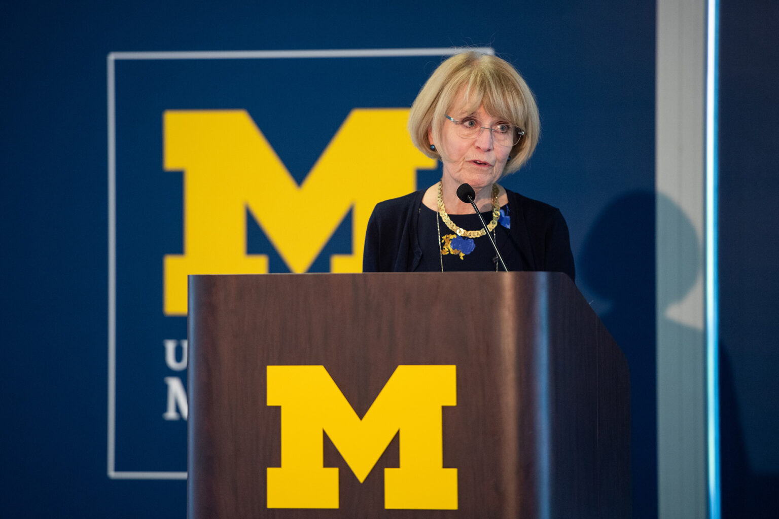 President Emerita Mary Sue Coleman speaks from the podium