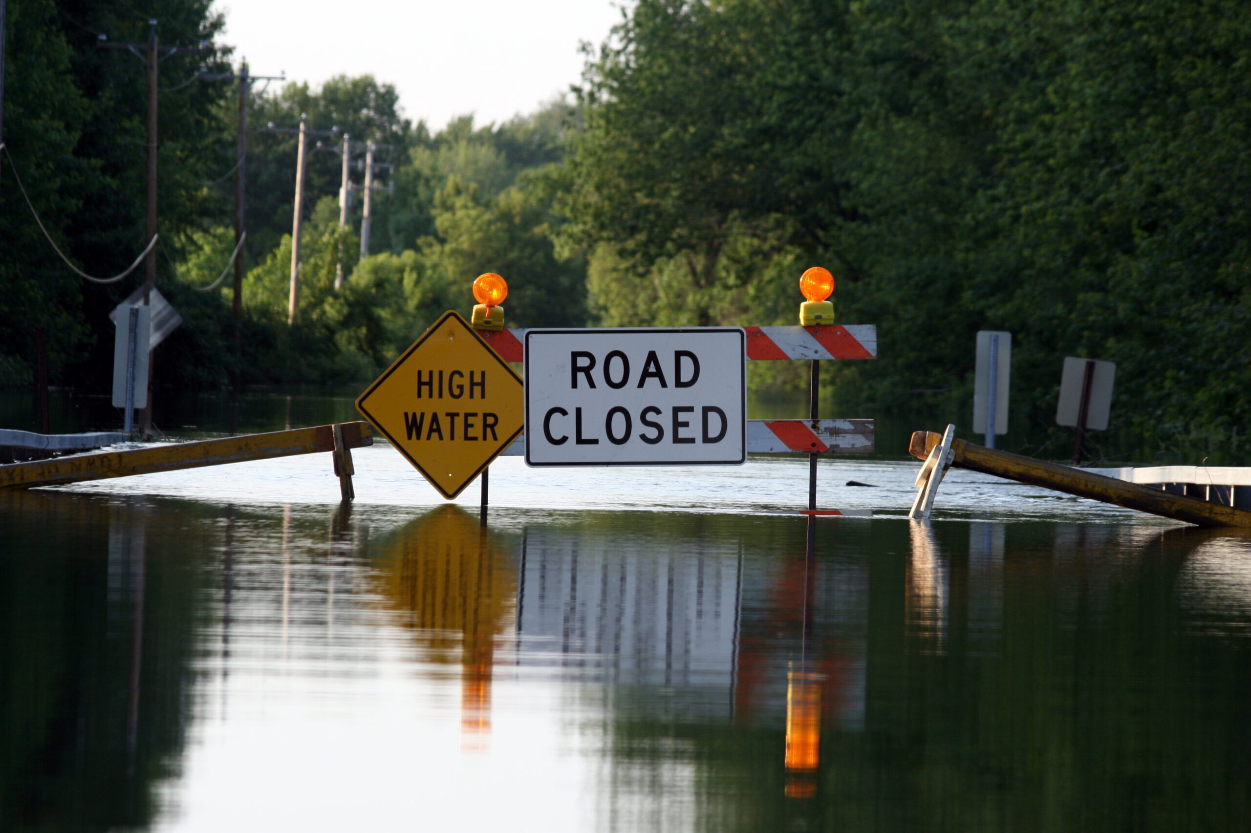 Stock photo of a road closed due to flooding.