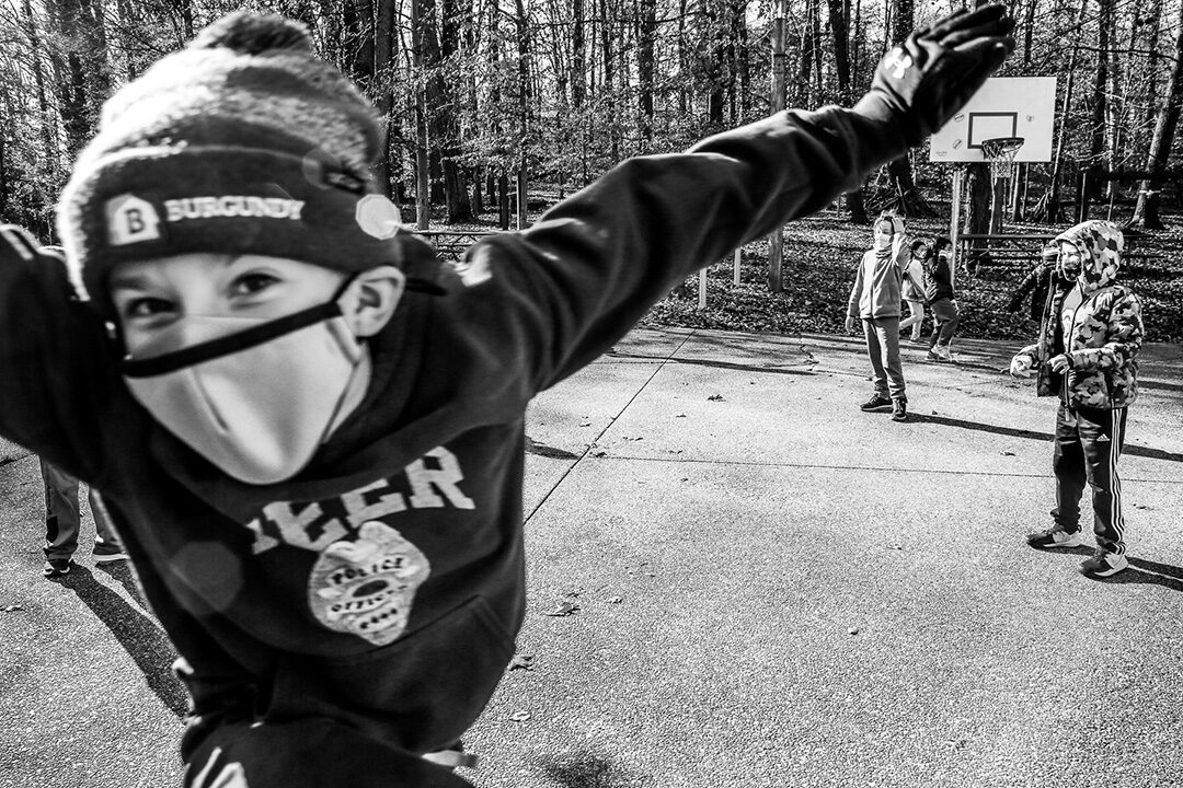 Photo bombing kid in a mask at play.