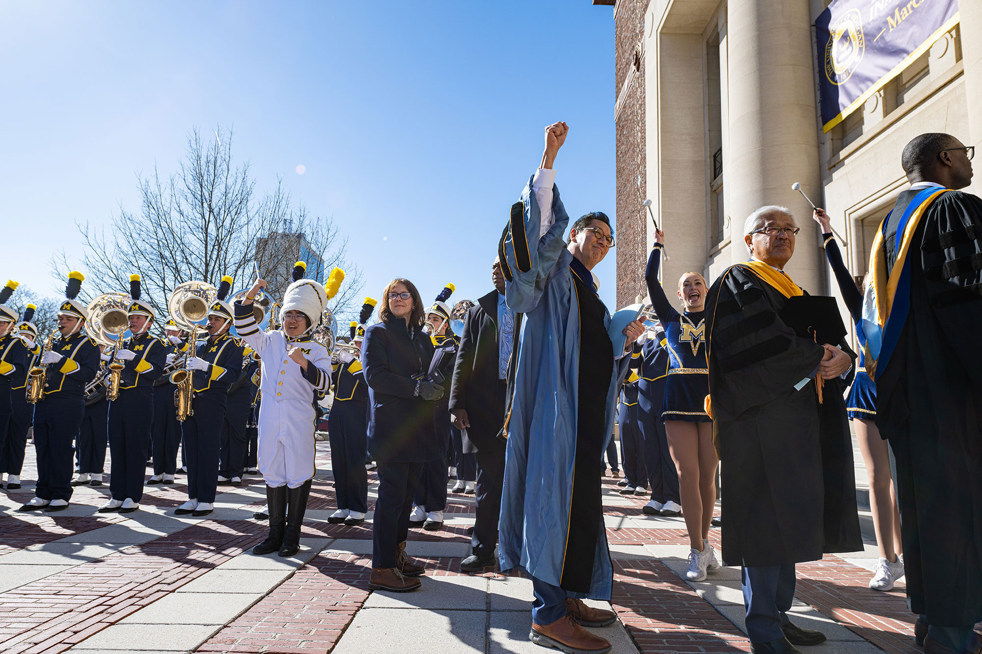 President Ono dressed for his inauguration is surrounded by the Michigan Marching Band on the steps of Hill Auditorium, March 23.