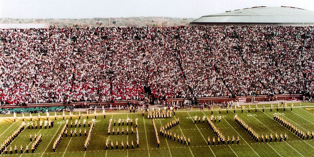 Michigan Marching Band spells out the name of Gaskill, who was the band photographer for seven decades. Image is from October 1992.