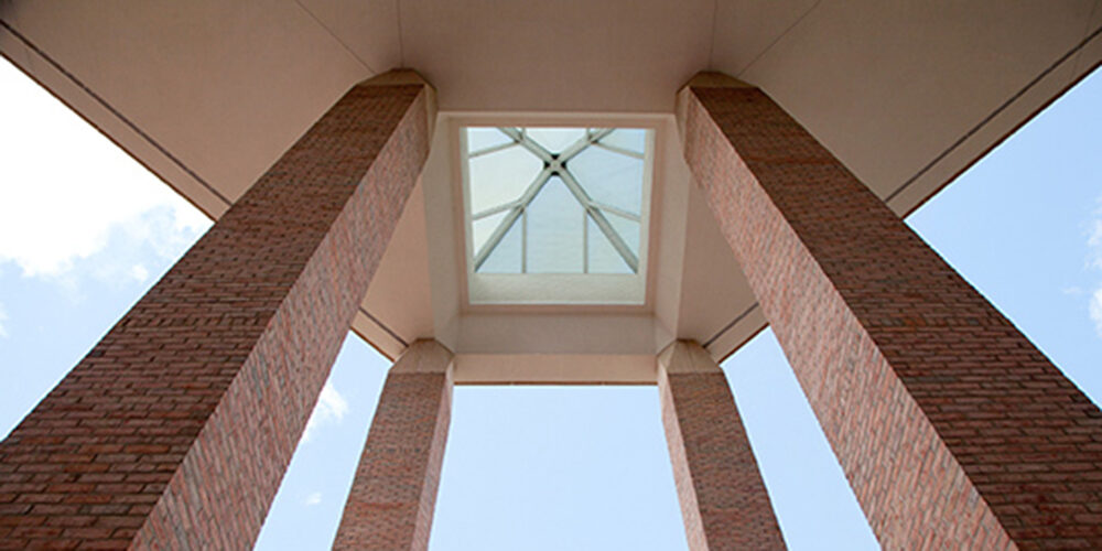 View of the Duderstadt pillars at the entrance of the building, taken from below looking up.