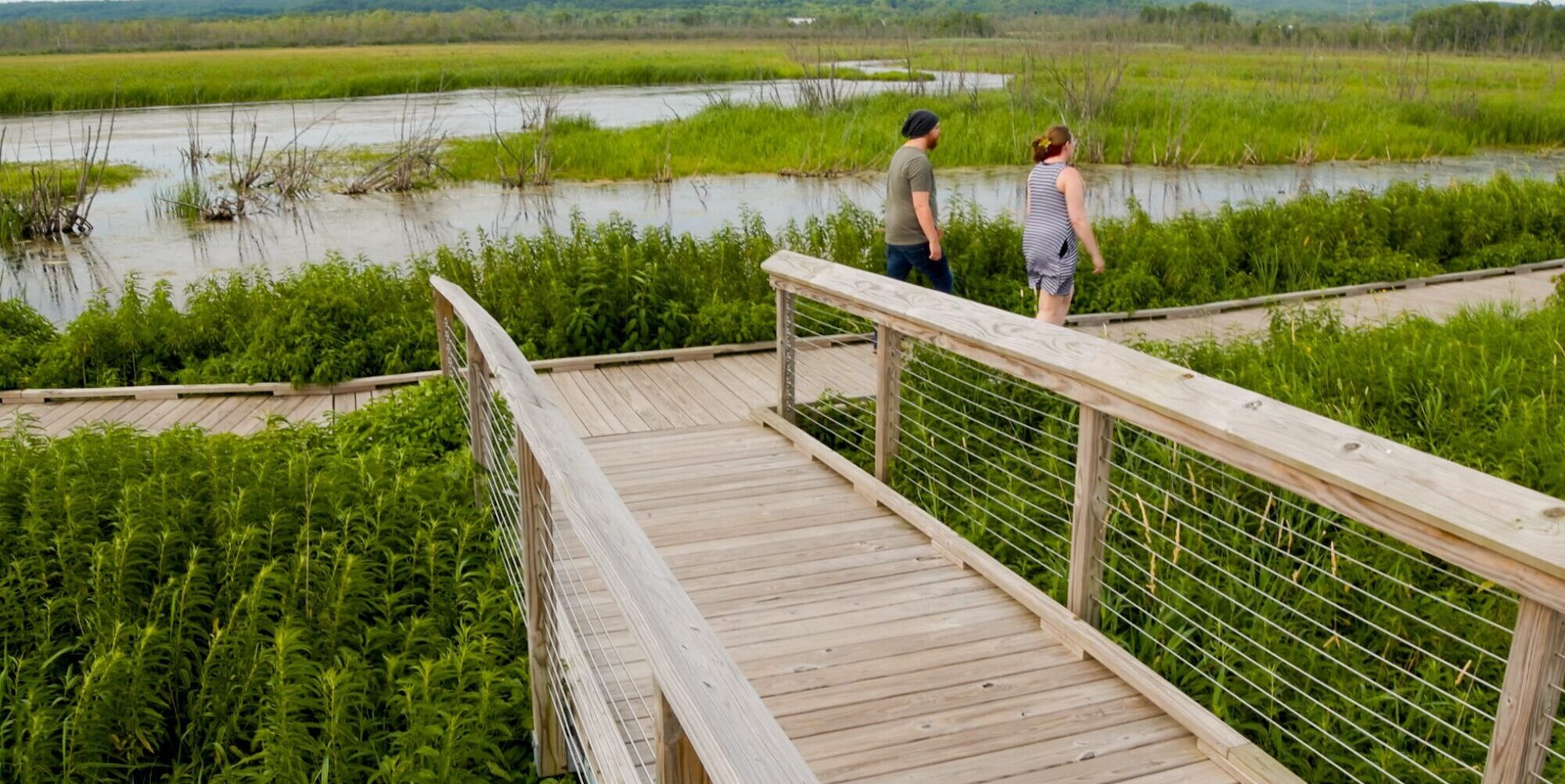 Two hikers walking along the universal trails at Arcadia Marsh.=