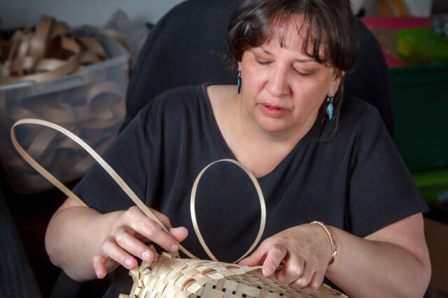 Woman weaves basket