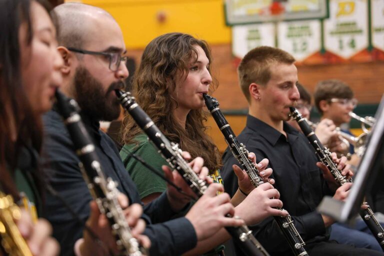 Members of the U-M Symphony Band perform with high school students in Michigan.